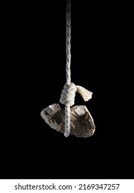 A stone tied to a rope. - Shutterstock ID 2169347257