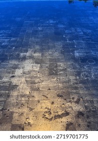 The stone tile at the bottom of the pool is refracted by yellow light