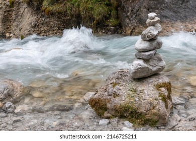 stone tower on a rock by the torrent