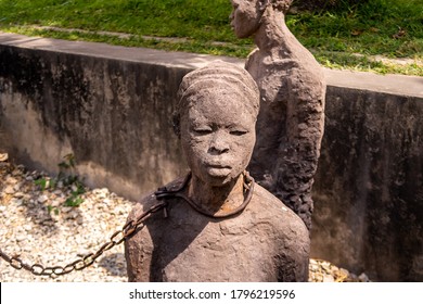 Stone Town, Zanzibar, 28/09/18. Memory for the Slaves by Clara Sornas - art installation of life-sized sculptures of slaves chained together in an open chamber in Old Slave Market, close-up view.