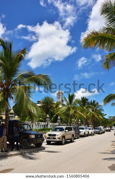 Stone Town, Zanzibar -\
October 7, 2019: Street of Stone Town on sunny day. Stone Town is\
the oldest part of Zanzibar City which was a UNESCO World Heritage\
Site in 2000