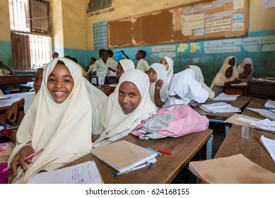 STONE TOWN, ZANZIBAR, TANZANIA CIRCA MARCH 2017, School girls and school boys smiling at camera in the class room.Wide angle and motion blur 