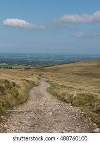 Stone Track on Okehampton Range with Granite Rocky Outcrop of Rowtor in the Background within Dartmoor National Park, Devon, England, UK