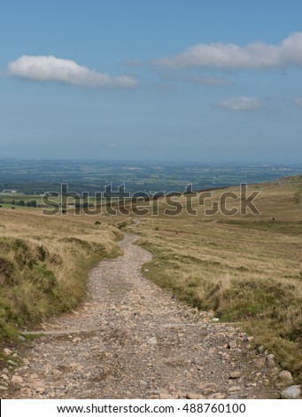 Stone Track on Okehampton Range with Granite Rocky Outcrop of Rowtor in the Background within Dartmoor National Park, Devon, England, UK
