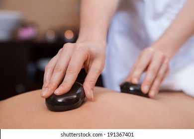 Stone Treatment. Woman Getting A Hot Stone Massage At A Day Spa