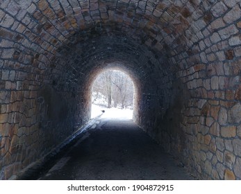 Stone tunnel in a snowy park