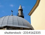 stone Turkish minaret and mosque in Pecs, Hungary. diminishing perspective. low angle view. Islamic architecture. landmark building. named after Jakovari Hassan. blue sky. travel and architecture.