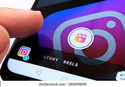 Stone / UK - August 31 2020: Instagram Reels seen in Instagram app on mobile phone and finger pointing at it. New feature from Facebook aimed to create competition with TikTok.