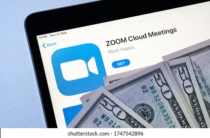 Stone /UK - May 28 2020: Zoom Cloud Meetings App In Apple App Store Seen On IPad Screen And Dollar Bills Placed On Top. Concept For Zoom Revenue And Share Price. 