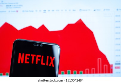 Stone, UK - September 24 2019: Netflix logo on the smartphone screen and the chart with share (NFLX) price for the last month at the blurred background. Netflix stock falls again.