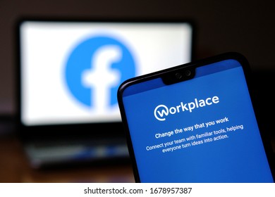 Stone, United Kingdom - March 21 2020:  Workplace App On The Smartphone And Blurred Facebook Logo On The Background. Workplace Is A Platform With Tools Like Groups, Instant Messaging And News Feed.