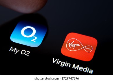 Stone  United Kingdom - May 12 2020: Virgin Media And My O2 Apps On Smartphone Screen And Finger Pressing One Of Them. Macro. Concept For Potential Merger Of The Two Telecom Companies.