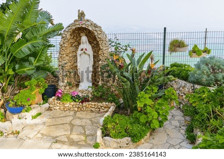The stone Virgin Mary statue in the garden of the Deir Al-Mukhraqa Carmelite Monastery, Israel