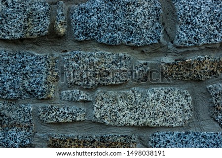 A stone wall with a different rhythm. The color of aging. Close-up.