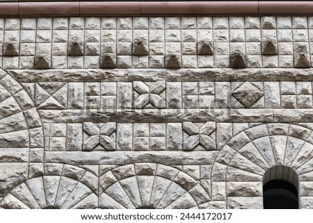 Stone wall with diverse pattern decorations. Colonial architectural feature or detail in Old City Hall Building (1898), Toronto, Canada