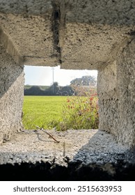 A stone wall. Green fields.