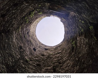 Stone well hole, old construction from inside, fall down in the well - Shutterstock ID 2298197031