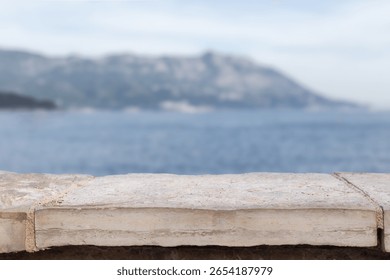 Stone white table display empty background with blurred sea bokeh. tabletop countertop product placement luxury mock up beach vacation summer products luxury coast mock up