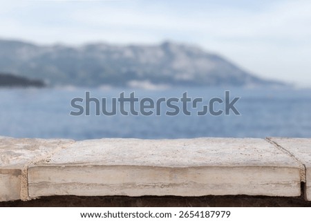Stone white table display empty background with blurred sea bokeh. tabletop countertop product placement luxury mock up beach vacation summer products luxury coast mock up