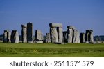 Stonehenge, Wiltshire, United Kingdom, August 29, 2024. Atmospheric ancient prehistoric neolithic stone circle or monument Focus on outer Sarsen stone circle. Outdoors on a sunny summer day