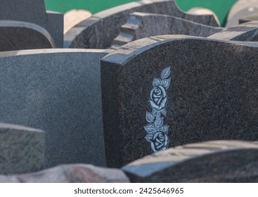 A stonemason has many gravestones for the bereaved to choose from