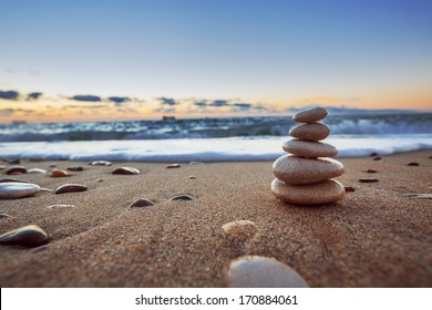 Stones balance on beach, sunrise shot 