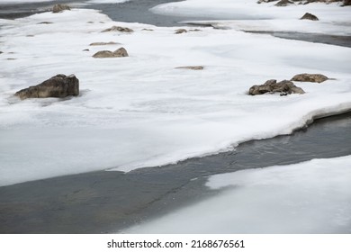 Stones In A Frozen River In Winter