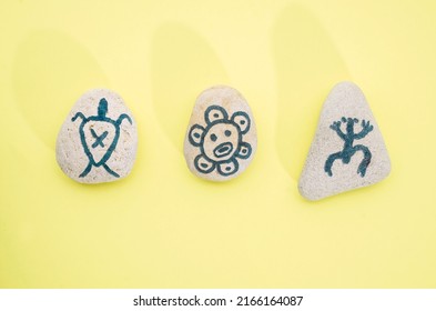 Stones With Hand-drawn Taino Petroglyphs Symbols, Craft With Children For Hispanic Heritage Month 