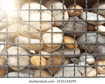 Stones In Metal Wire Cage. Simple And Creative Wall.  DIY Fence For Home.

