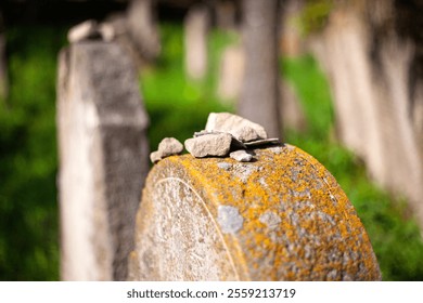 Stones on an old grave at the Jewish cemetery in Muszyna, southern Poland. - Powered by Shutterstock