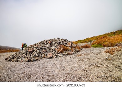 Stones piled up on a misty mountain trail. It's called "Cairn" - Powered by Shutterstock