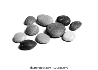 Stones, sea pebbles isolated on white background. Heap of scattered stones, smooth gray and black pebbles