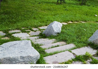 Stones And Stone Steps Among Lush Green Grass