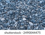 Stones texture. Gray and black pebble background ,pebbles on a pebble beach, top view