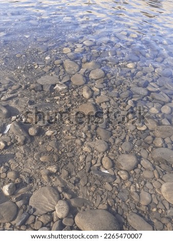 Stones view under lucent , clean and fresh flowing water 
