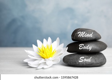 Stones with words Mind, Body, Soul and lotus flower on white wooden table. Zen lifestyle - Shutterstock ID 1595867428