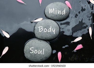 Stones with words Mind, Body, Soul and flower petals in water, flat lay. Zen lifestyle - Shutterstock ID 1921960103