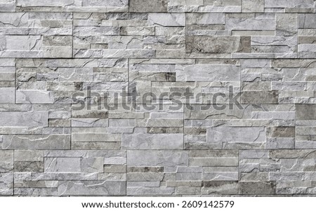 Stoneware paneling wall with stone effect. Colors are shades of gray and brown. Background and texture.