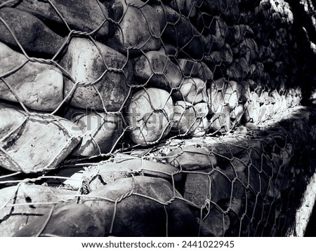Stonework Stability: Wire Mesh Reinforcing a Stone Wall