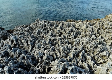 Stony ocean coast. Gray sharp rocky stones ashore