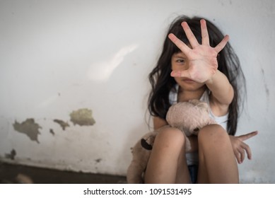 Stop abusing violence. violence, terrified , A fearful child, kid girl showing hand signaling to stop useful to campaign against violence and pain. human rights day concept. copy space