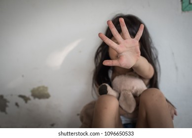 Stop abusing violence. violence, terrified , A fearful child, kid girl showing hand signaling to stop useful to campaign against violence and pain. human rights day concept. copy space
