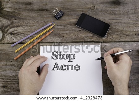 Stop Acne. Text on a sheet of paper. 