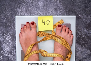 Stop Anorexia Nervosa! Concept Of Society Perception And Pressure About Weight Problem. Skinny Female Feet On A Scale With Yellow Measuring Tape. Loss Weight Social Stigma.