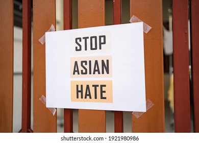 Stop Asian Hate sign was attached on the house fence - Shutterstock ID 1921980986