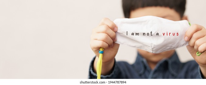 Stop asian hate, Violence, Harassment bullying in school concept. An asian little boy hold a face mask toward with words "I am not a virus" on it. AAPI, Ethnicity Racism during Covid-19 pandemic. Kids - Powered by Shutterstock