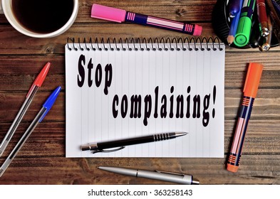 Stop Complaining Written On Notebook