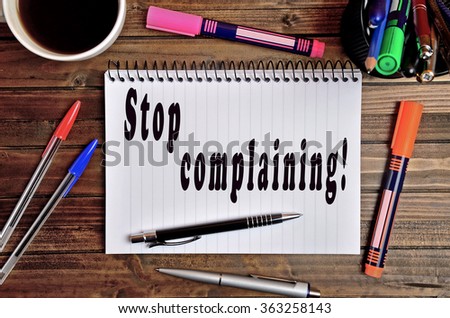 Stop complaining written on notebook