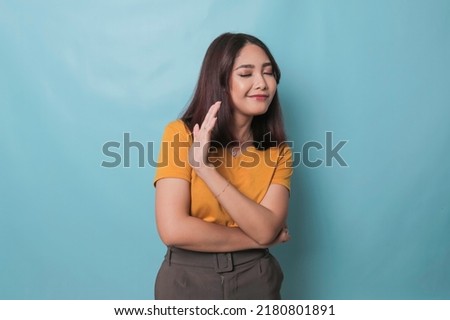 Stop. Concerned Asian woman showing refusal sign, saying no, raise awareness, standing over blue background Stock foto © 