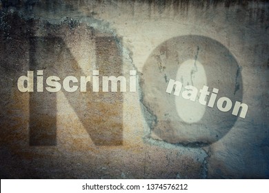 Stop Discrimination Agains Minorities On Grounds Of Race, Sex Or Religion As Text Written On A Cracked Concrete Wall Showing Injustice, Unfairness Metaphor. Human Inequality As Global Social Issue. 